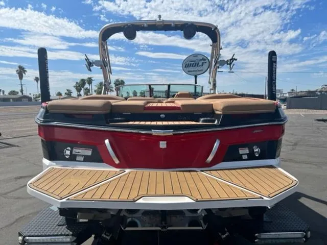 Slide: The Image of 2019 MasterCraft XT25 boat with red and white exterior, rear view. - 7