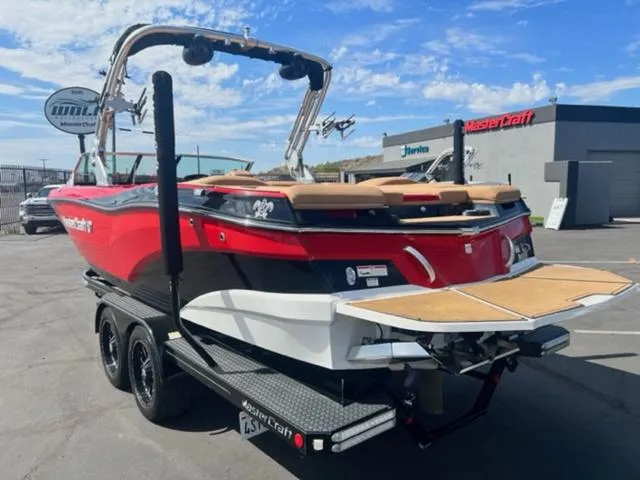 Slide: The Image of 2019 MasterCraft XT25 boat on trailer, red and black exterior, rear view. - 9