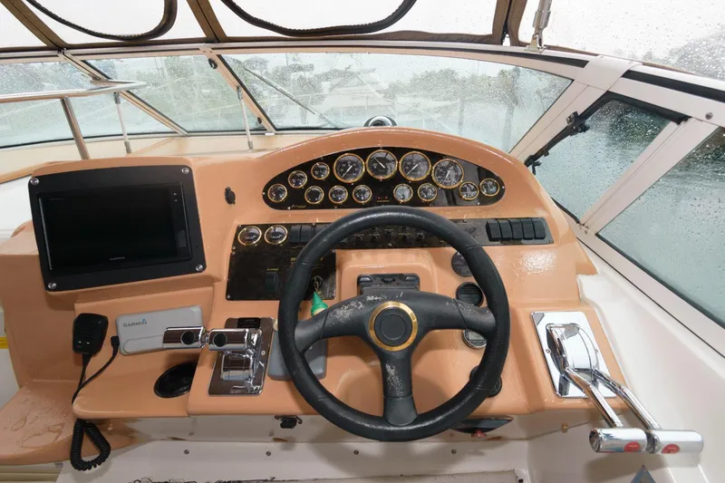 Slide: The Image of 2002 Cruisers Yachts 3372 Express helm with steering wheel and instrument panel. - 10