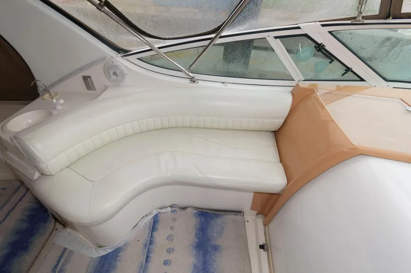 Slide: The Image of 2002 Cruisers Yachts 3372 Express interior seating area with white leather upholstery. - 11