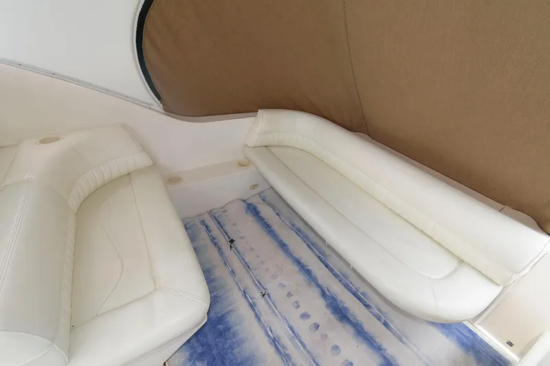 Slide: The Image of Interior seating of 2002 Cruisers Yachts 3372 Express with white leather upholstery. - 12