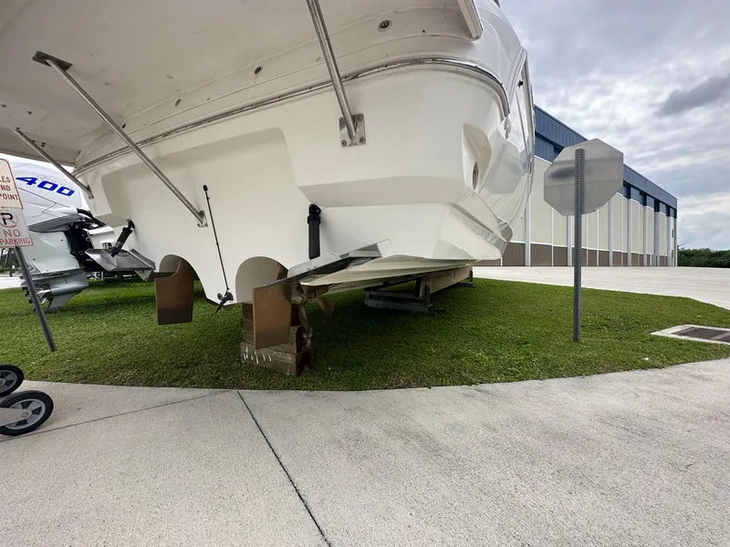 Slide: The Image of 2002 Cruisers Yachts 3372 Express on dry dock, showing propellers and stern. - 13