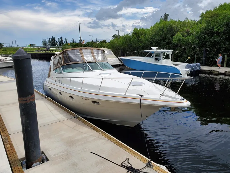 Slide: The Image of 2002 Cruisers Yachts 3372 Express docked at a marina. - 2