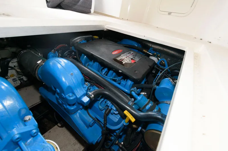 Slide: The Image of Engine compartment of a 2002 Cruisers Yachts 3372 Express with blue engine components. - 26