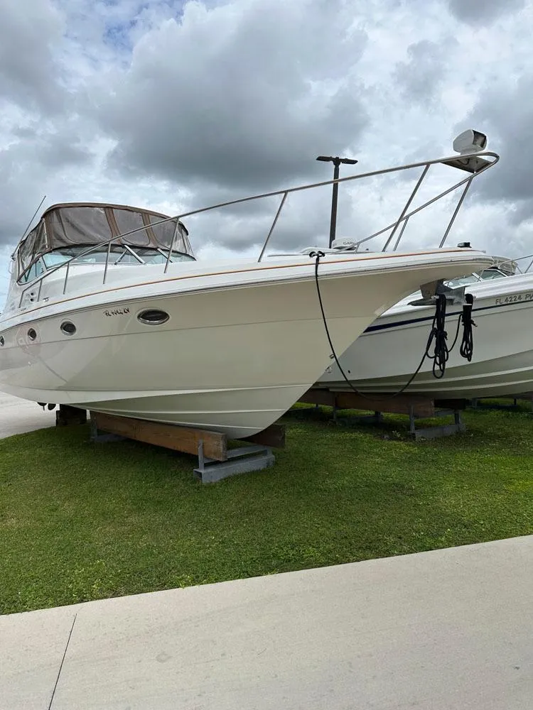 Slide: The Image of 2002 Cruisers Yachts 3372 Express boat on display, docked on land. - 5