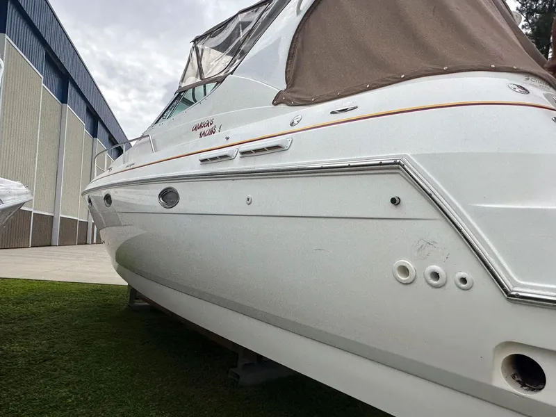 Slide: The Image of 2002 Cruisers Yachts 3372 Express docked on grass near a building. - 7