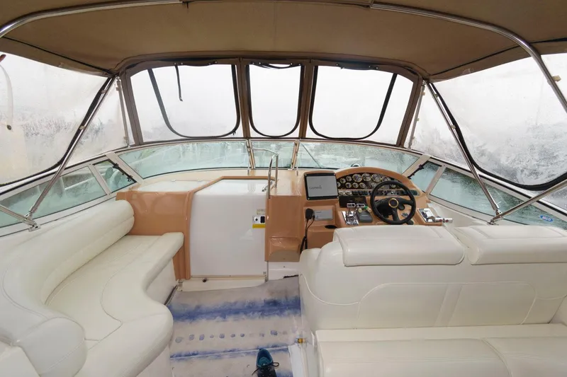 Slide: The Image of Interior helm of 2002 Cruisers Yachts 3372 Express with leather seating and navigation controls. - 8