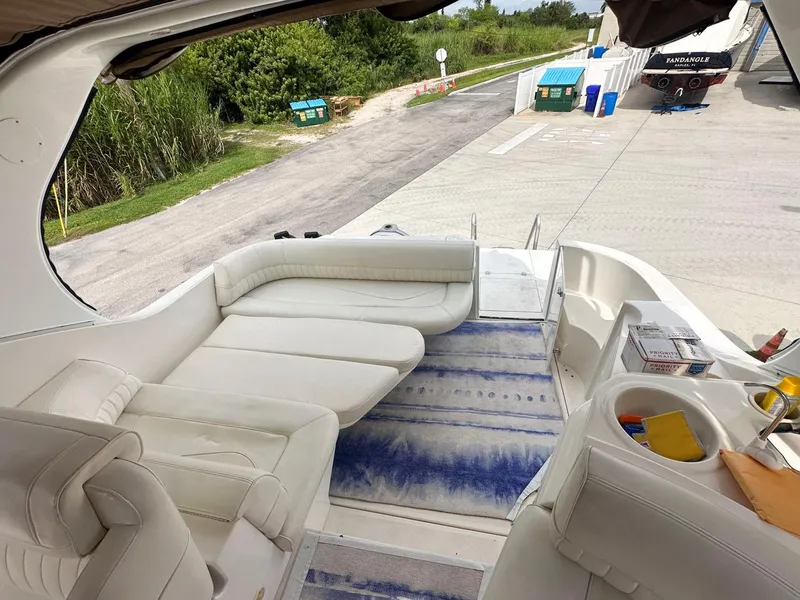 Slide: The Image of 2002 Cruisers Yachts 3372 Express interior with white seating and blue rug. - 15