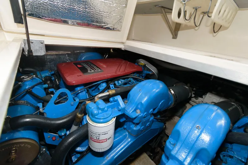 Slide: The Image of Engine compartment of a 2002 Cruisers Yachts 3372 Express with blue engine components. - 27