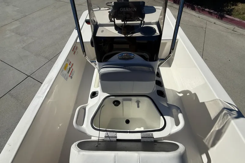 Slide: The Image of 2024 Mako Pro Skiff 13 CC interior with console and seating, featuring Garmin electronics. - 11