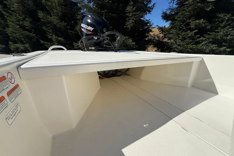 Slide: The Image of 2024 Mako Pro Skiff 13 CC boat with Mercury engine, outdoor setting. - 14