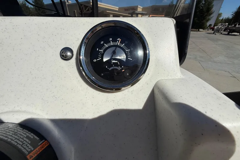 Slide: The Image of Close-up of 2024 Mako Pro Skiff 13 CC tachometer on speckled dashboard. - 16