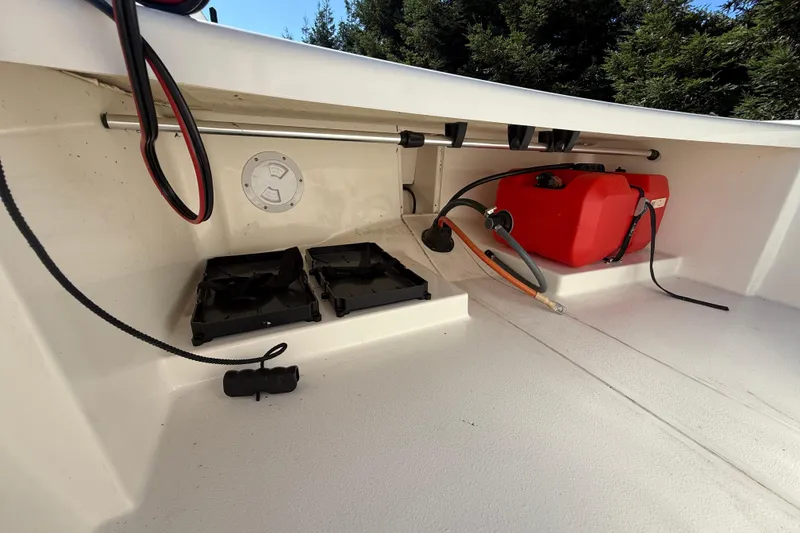 Slide: The Image of 2024 Mako Pro Skiff 13 CC interior with fuel tank and storage compartments. - 13