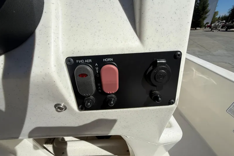 Slide: The Image of Control panel of 2024 Mako Pro Skiff 13 CC with switches and 12V outlet. - 18