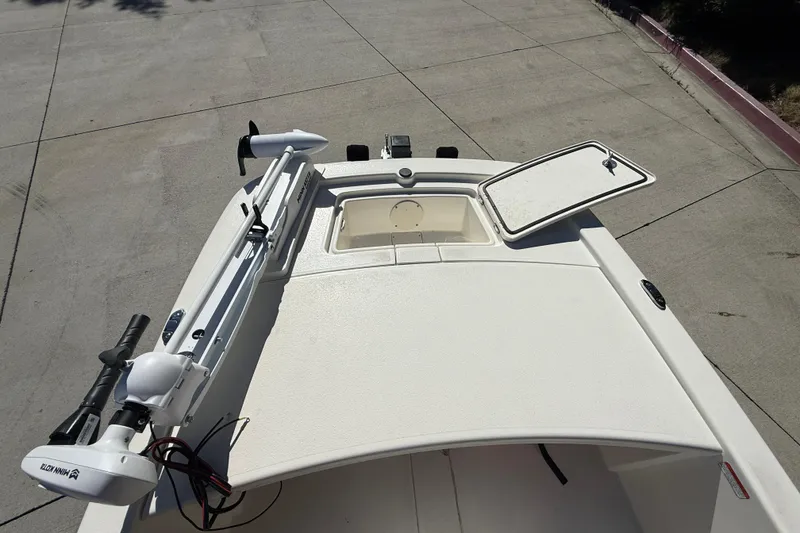 Slide: The Image of 2024 Mako Pro Skiff 13 CC boat deck with open storage compartment. - 9
