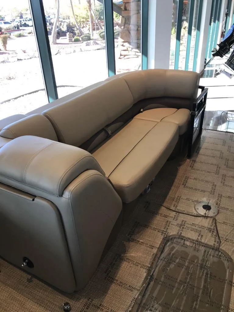 Slide: The Image of 2024 Regency 230 DL3 boat interior with plush seating and modern design. - 12