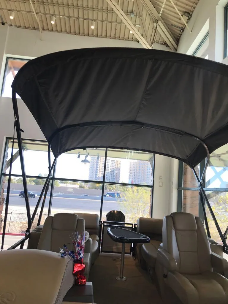 Slide: The Image of 2024 Regency 230 DL3 pontoon boat with canopy in showroom. - 5