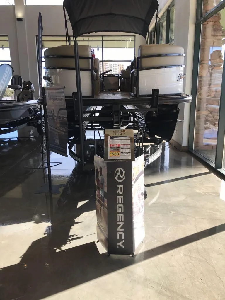 Slide: The Image of 2024 Regency 230 DL3 pontoon boat displayed in showroom. - 7