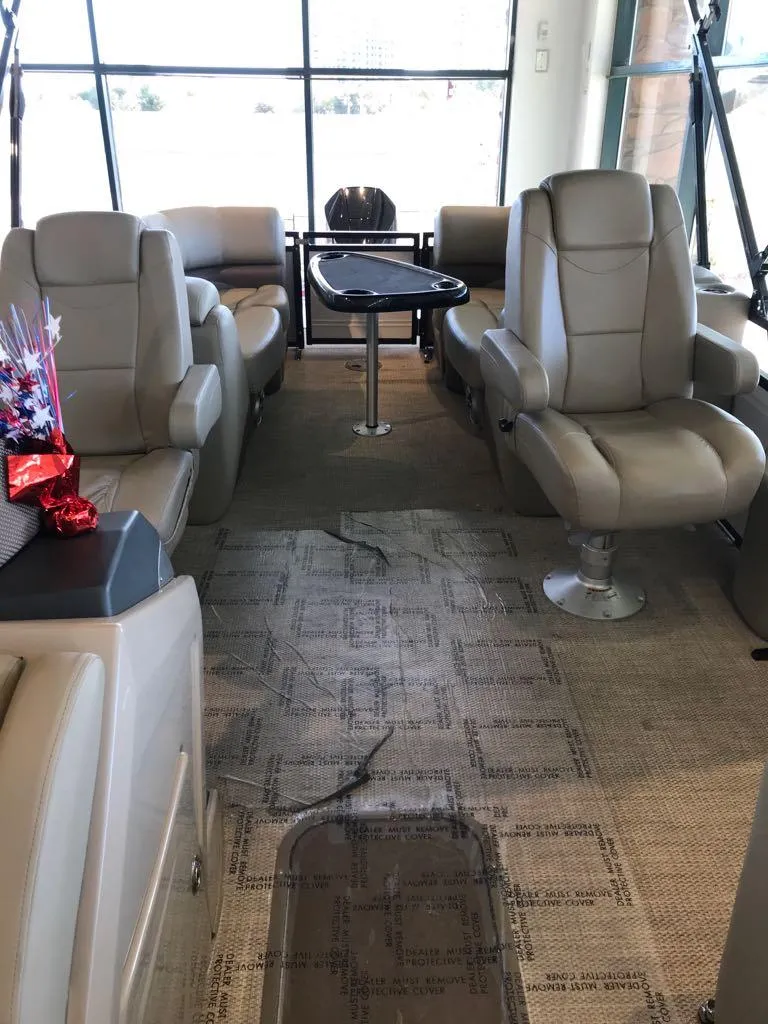Slide: The Image of Luxurious interior of 2024 Regency 230 DL3 pontoon boat with plush seating. - 9