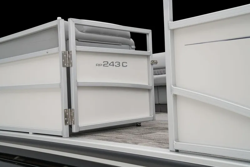 Slide: The Image of 2024 Ranger Reata 243C pontoon boat entry gate and seating area. - 10