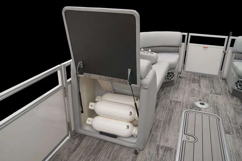 Slide: The Image of 2024 Ranger Reata 243C pontoon boat with open storage compartment and gray seating. - 28