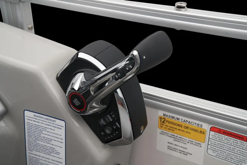 Slide: The Image of 2024 Ranger Reata 243C boat throttle control and capacity warning labels. - 44