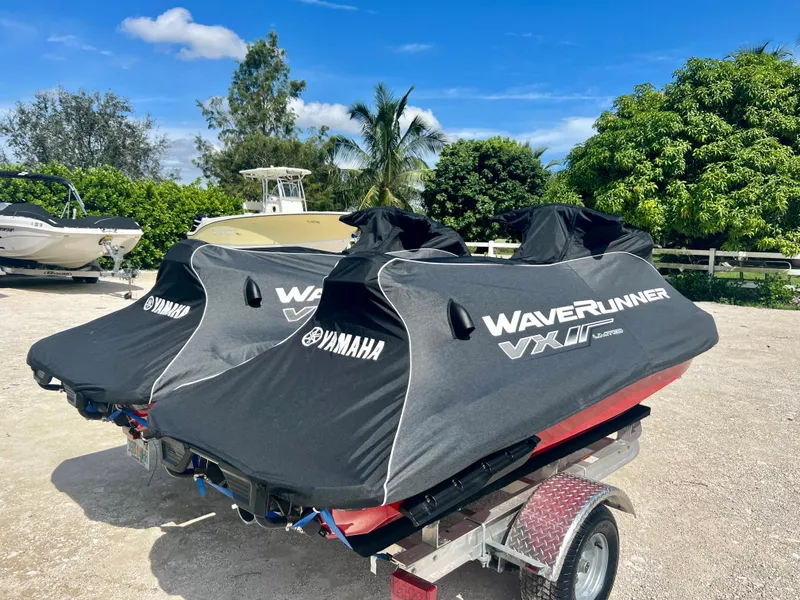 Slide: The Image of 2022 Yamaha WaveRunner VX Cruisers Limited jet skis on a trailer, covered and ready for transport. - 16