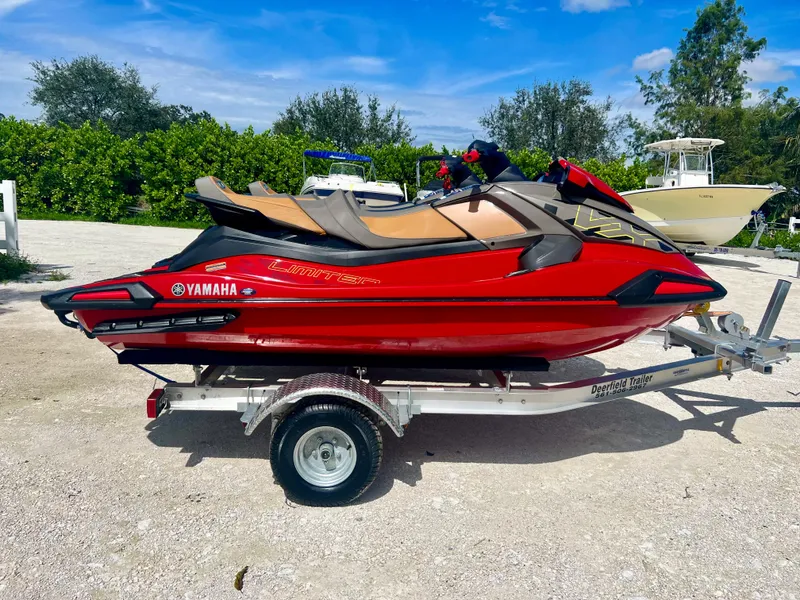 Slide: The Image of 2022 Yamaha WaveRunner VX Cruisers Limited on trailer, red and black, parked outdoors. - 5