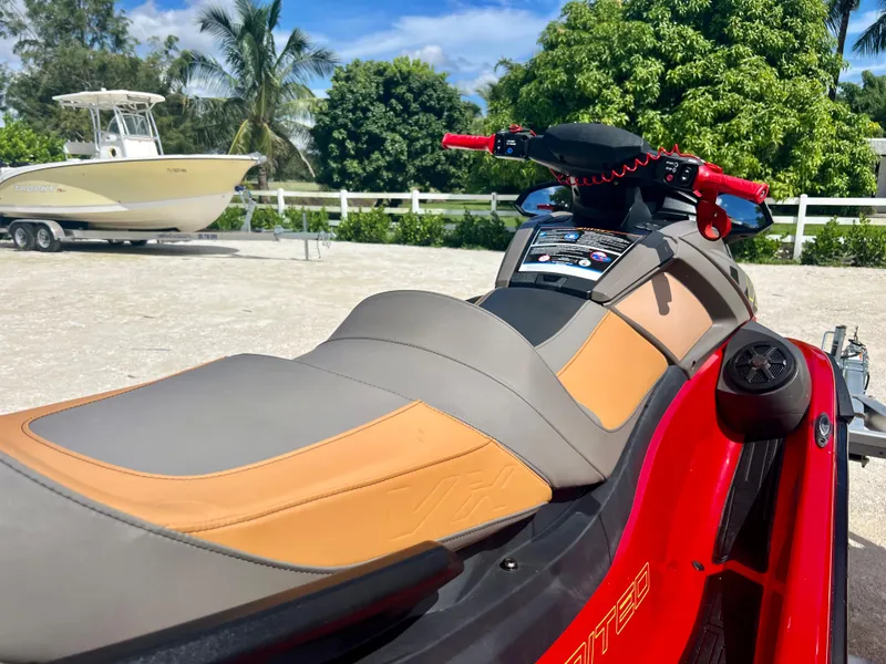 Slide: The Image of 2022 Yamaha WaveRunner VX Cruisers Limited in red, parked outdoors near a boat. - 9