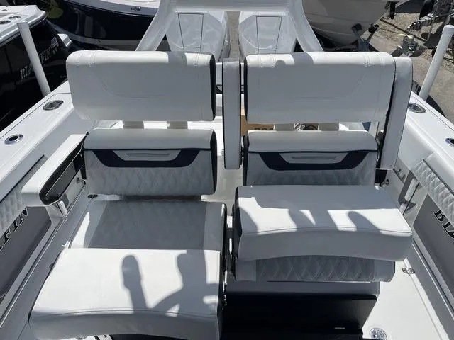Slide: The Image of 2023 Blackfin 272CC boat interior with white cushioned seats. - 12