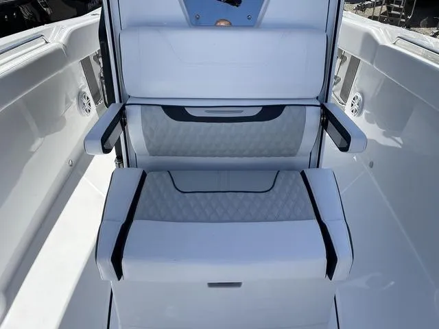 Slide: The Image of 2023 Blackfin 272CC boat interior seating with armrests and diamond-stitched upholstery. - 20