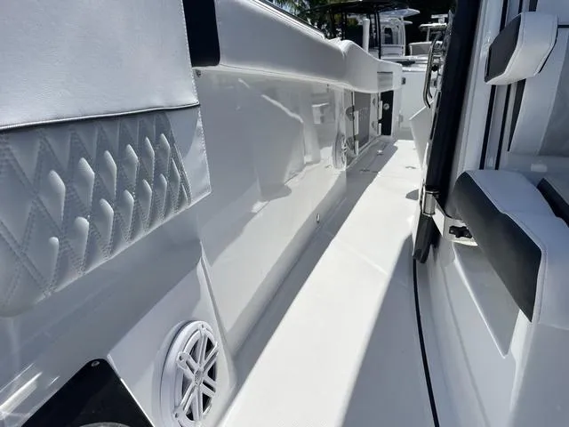 Slide: The Image of 2023 Blackfin 272CC boat interior, white seating, and speaker detail. - 24