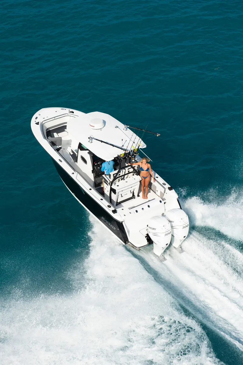Slide: The Image of 2023 Blackfin 272CC boat cruising on blue water. - 39