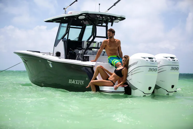 Slide: The Image of 2023 Blackfin 272CC boat with two people relaxing on the water. - 41
