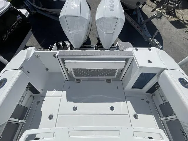 Slide: The Image of 2023 Blackfin 272CC boat deck with twin outboard engines. - 6