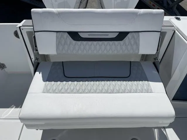 Slide: The Image of 2023 Blackfin 272CC boat with white cushioned seating. - 8