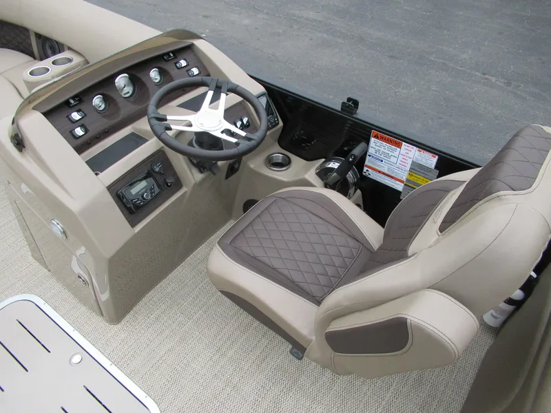 Slide: The Image of 2024 Bennington 22 LFB boat cockpit with steering wheel and captain's chair. - 3