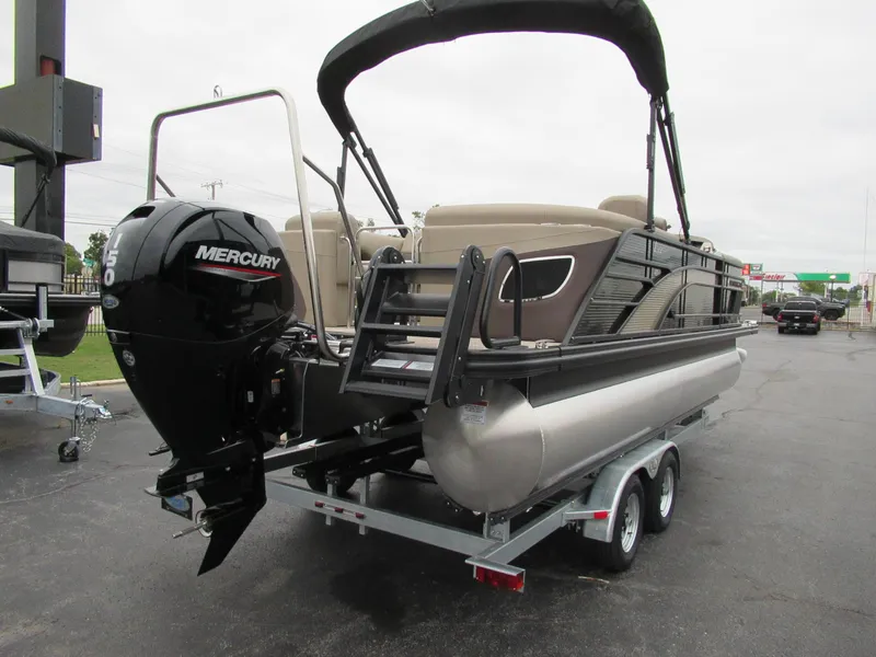 Slide: The Image of 2024 Bennington 22 LFB pontoon boat with Mercury outboard engine on trailer. - 5
