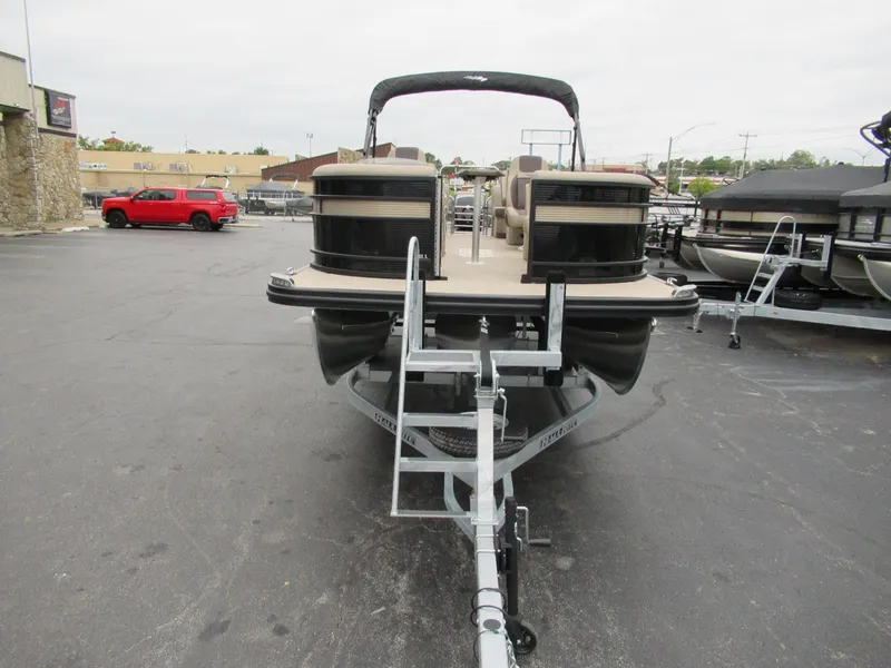 Slide: The Image of 2024 Bennington 22 LFB pontoon boat on a trailer in a parking lot. - 6