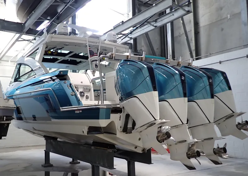 Slide: The Image of 2020 Formula 430 All Sport Crossover boat with four outboard engines in a workshop. - 10