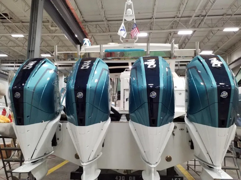 Slide: The Image of 2020 Formula 430 All Sport Crossover with quad outboard engines in a warehouse. - 11