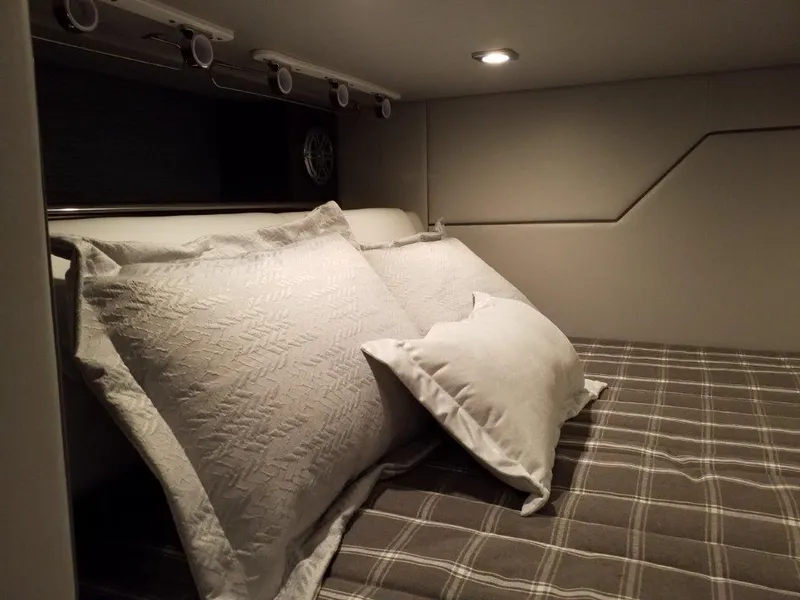 Slide: The Image of 2020 Formula 430 All Sport Crossover cabin bed with pillows and plaid bedding. - 18