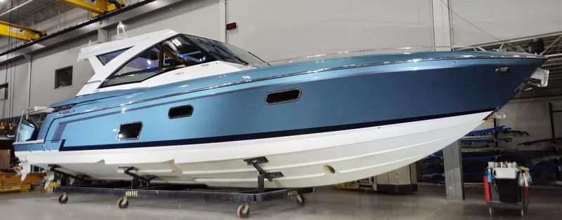 Slide: The Image of 2020 Formula 430 All Sport Crossover boat in a showroom setting. - 2