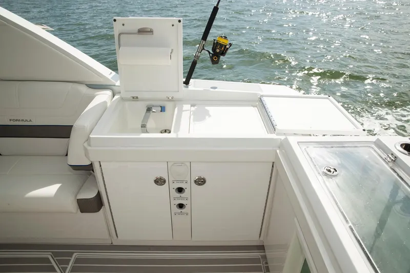 Slide: The Image of 2020 Formula 430 All Sport Crossover boat interior with fishing rod holder and storage compartments. - 35