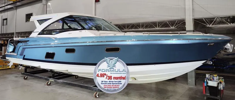 Slide: The Image of 2020 Formula 430 All Sport Crossover boat in showroom, blue and white exterior. - 43