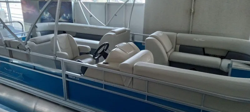 The Image of 2024 SunChaser Vista 22 LR pontoon boat with blue exterior and spacious seating. - 0