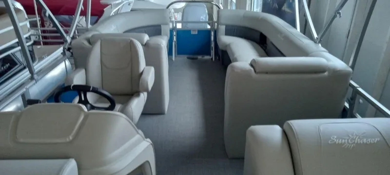 Slide: The Image of 2024 SunChaser Vista 22 LR pontoon boat interior with plush seating and steering console. - 13