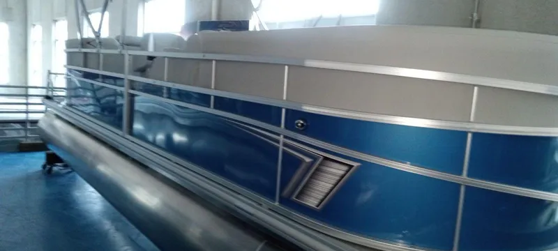 Slide: The Image of 2024 SunChaser Vista 22 LR pontoon boat in a showroom. - 3