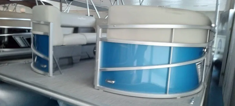 Slide: The Image of 2024 SunChaser Vista 22 LR pontoon boat with blue and beige seating. - 4