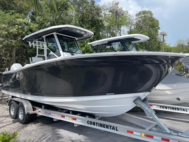 Slide: The Image of 2023 Blackfin 272CC boat on a Continental trailer. - 1